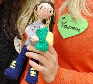 Choir member Yasmin holds the homemade doll which is made to look just like her.